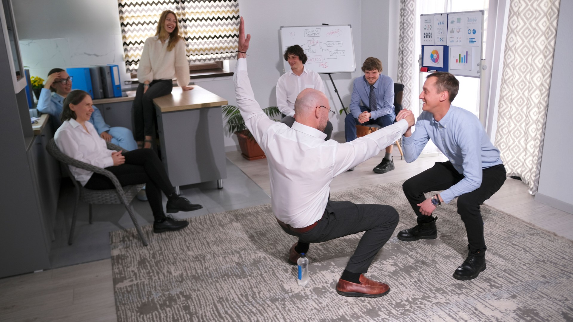 Businessmen are playing a game of trust, balance, and support. A team building event at a country house. A retreat from a mentor